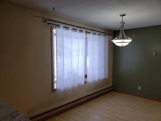 A room with a window and a light fixture.