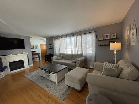 A living room with couches and a fireplace.