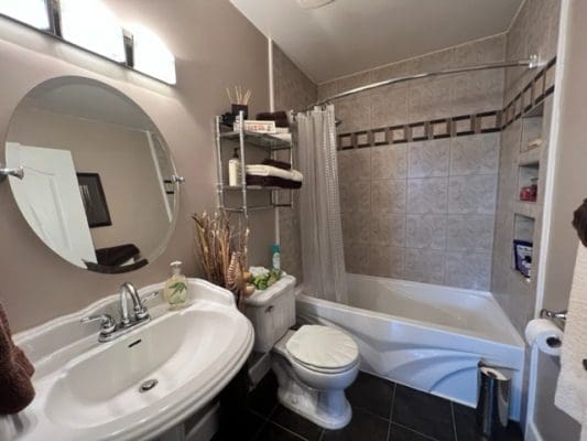 A bathroom with a bathtub, sink and toilet.