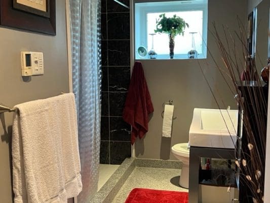 A bathroom with a shower, sink and toilet.