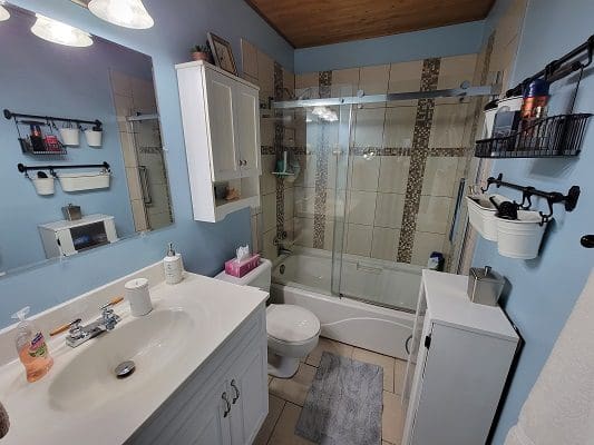A bathroom with blue walls and a bathtub.