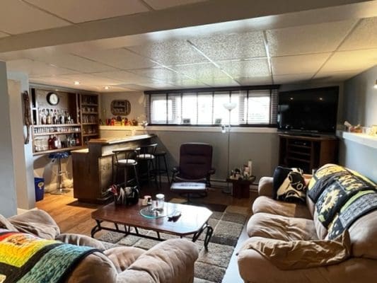 A living room with couches and a bar.