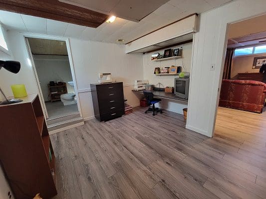 A room with wood floors and a desk.