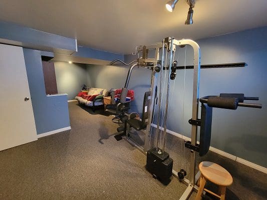 A gym equipment in a room with blue walls.
