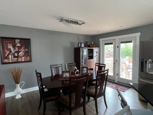 A kitchen with a dining table and chairs.