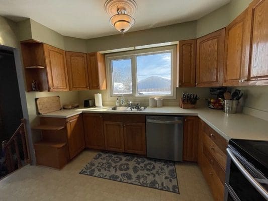 A kitchen with wooden cabinets and a window.