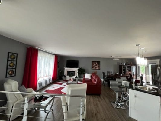 A living room with red curtains and red furniture.
