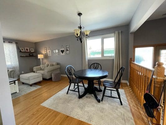 A living room with a dining table and chairs.