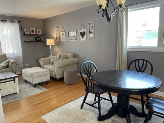 A living room with a table and chairs.