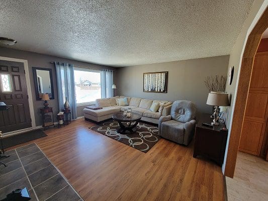 A living room with hardwood floors and a couch.