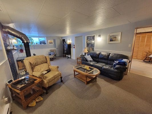 A living room with couches and a fireplace.