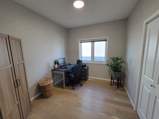 A room with a desk and a window.