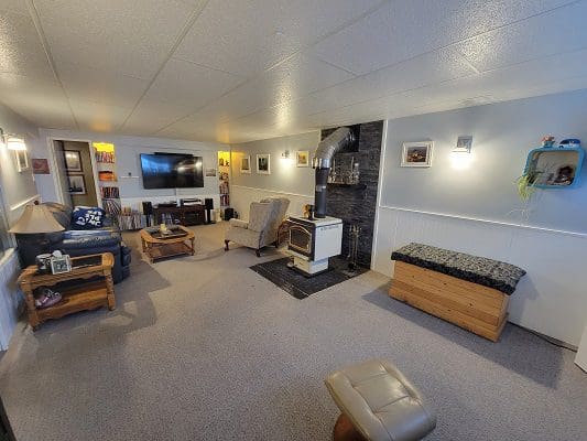 A living room with couches and a fireplace.