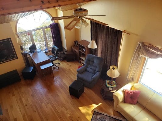 An aerial view of a living room with a ceiling fan.