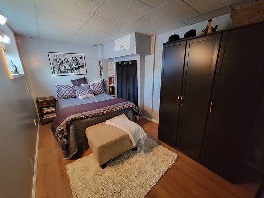 A bedroom with a bed and a closet.