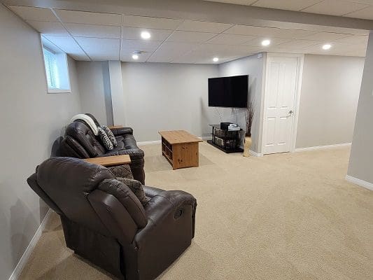 A living room with couches and a tv.