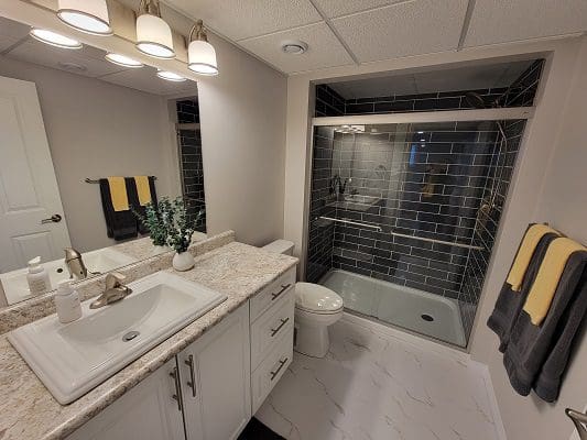 A bathroom with a shower and sink.