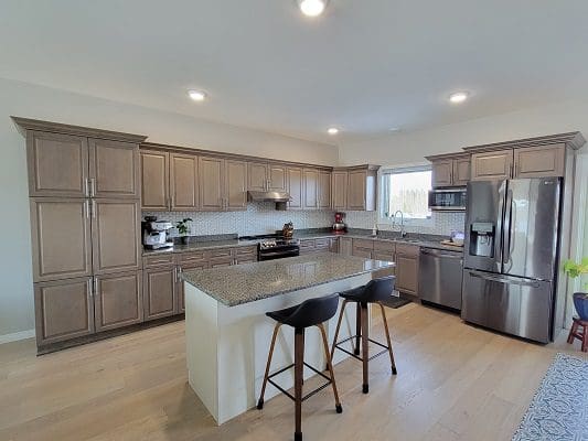 A kitchen with stainless steel appliances and hardwood floors.