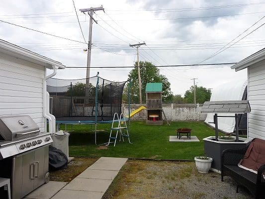 A backyard with a grill and bbq.