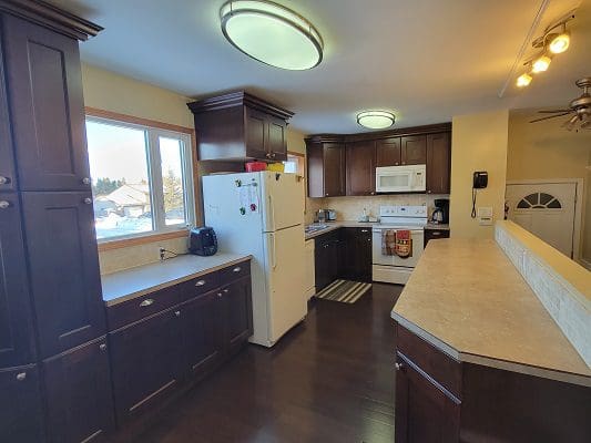 A kitchen with brown cabinets and stainless steel appliances.