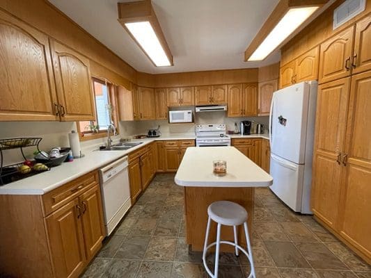 A kitchen with wooden cabinets and counter tops.
