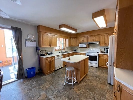 A kitchen with wooden cabinets and counter tops.