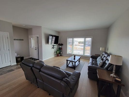 A living room with couches and a tv.