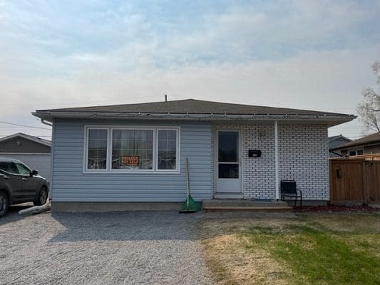 A house with a car parked in front of it.
