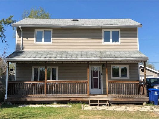 A house with a front porch and a back deck.