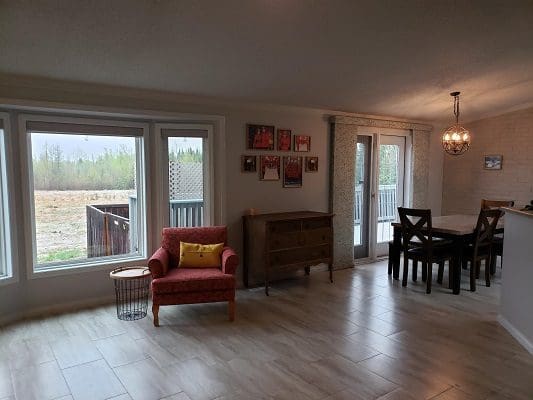 A living room with a dining table and chairs.