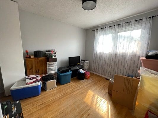 A room with a tv, a tv stand, and a tv.