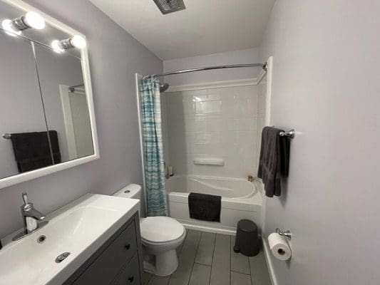 A bathroom with a sink toilet and shower.