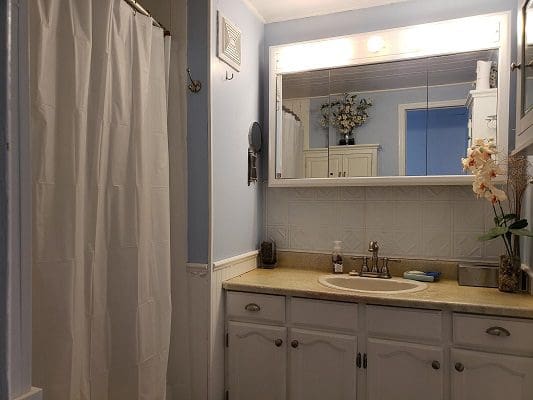 A bathroom with blue walls and a white sink.