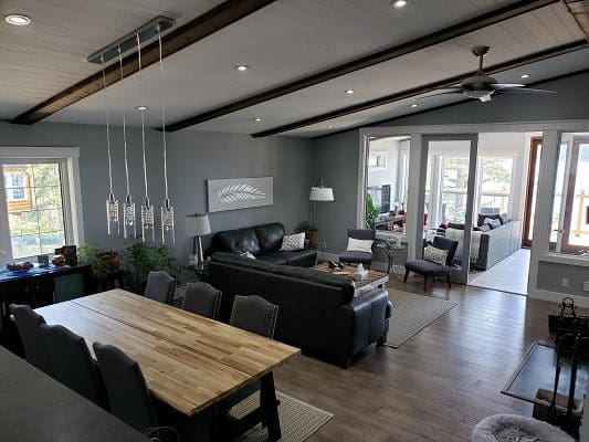 A living room with hardwood floors and a dining table.