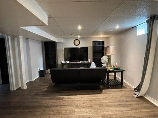 A living room with hardwood floors and a tv.