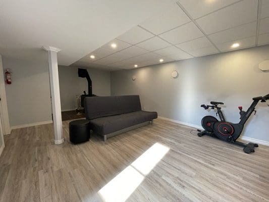 A gym room with a treadmill and exercise bike.