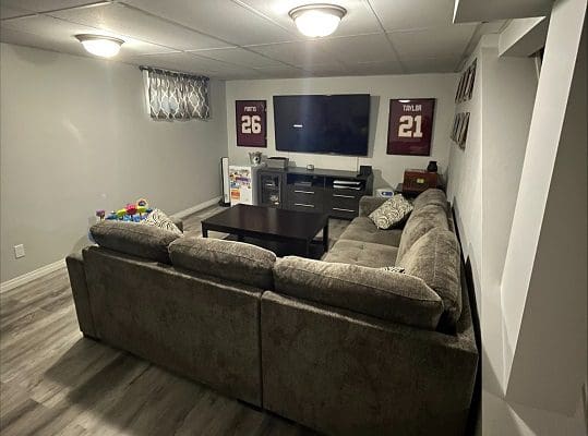 A living room with a couch and tv.