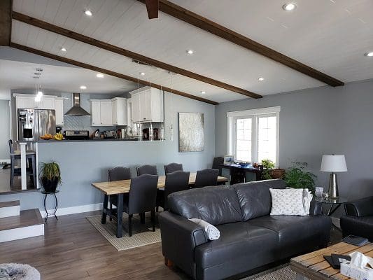 A living room with hardwood floors and a ceiling fan.