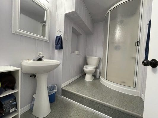 A bathroom with a sink, toilet and shower.