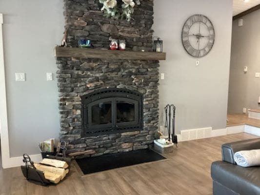 A stone fireplace in a living room.