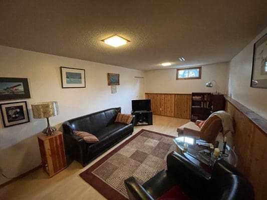 A living room with a couch and tv.