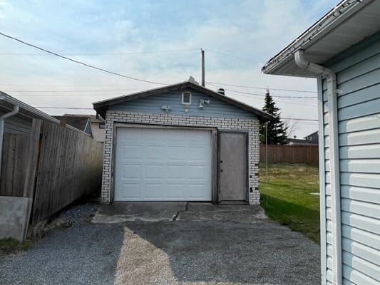 An image of a garage in a backyard.