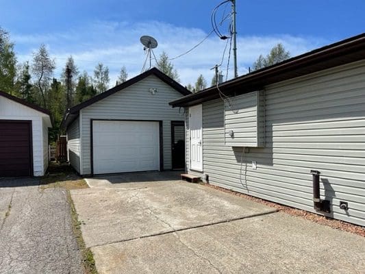 A house with two garages and a driveway.