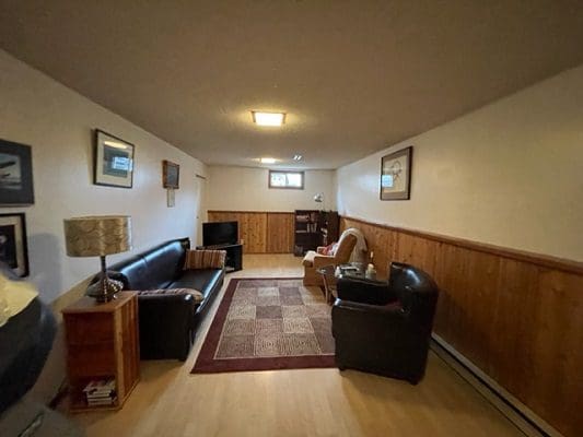 A living room with couches and a television.