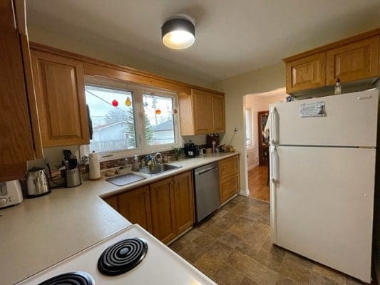 A kitchen with a stove and refrigerator.