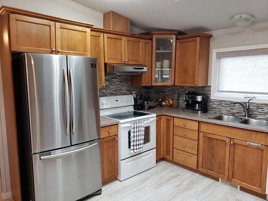 A kitchen with wooden cabinets and stainless steel appliances.