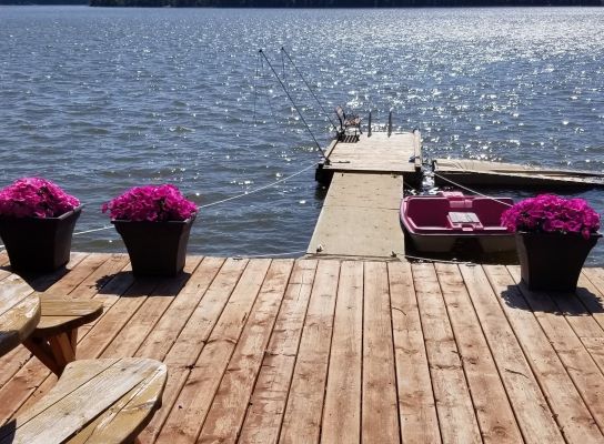 A dock with a boat and flowers on it.