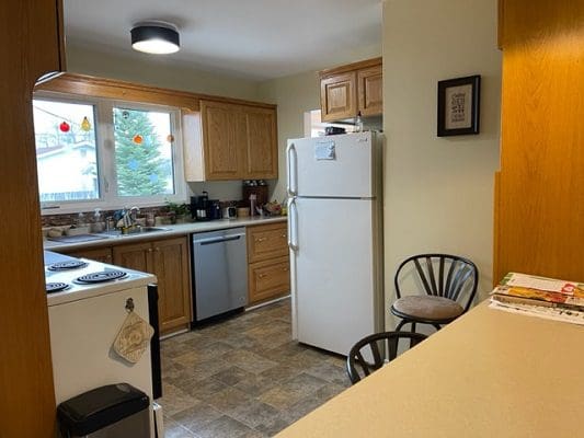 A kitchen with a stove and refrigerator.