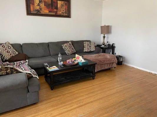 A living room with a couch and coffee table.