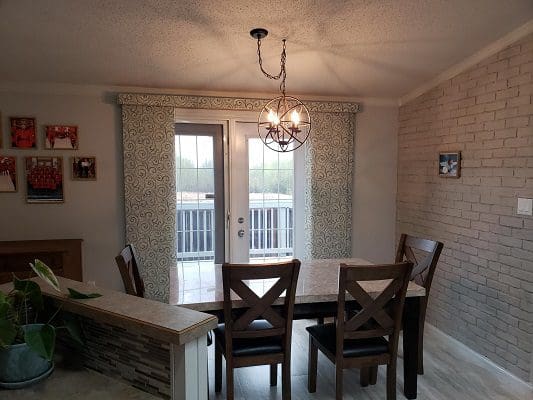 A dining room with a table and chairs.
